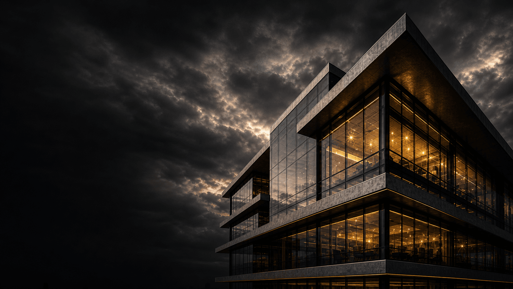 Dark modern glass architecture with gold interior lighting